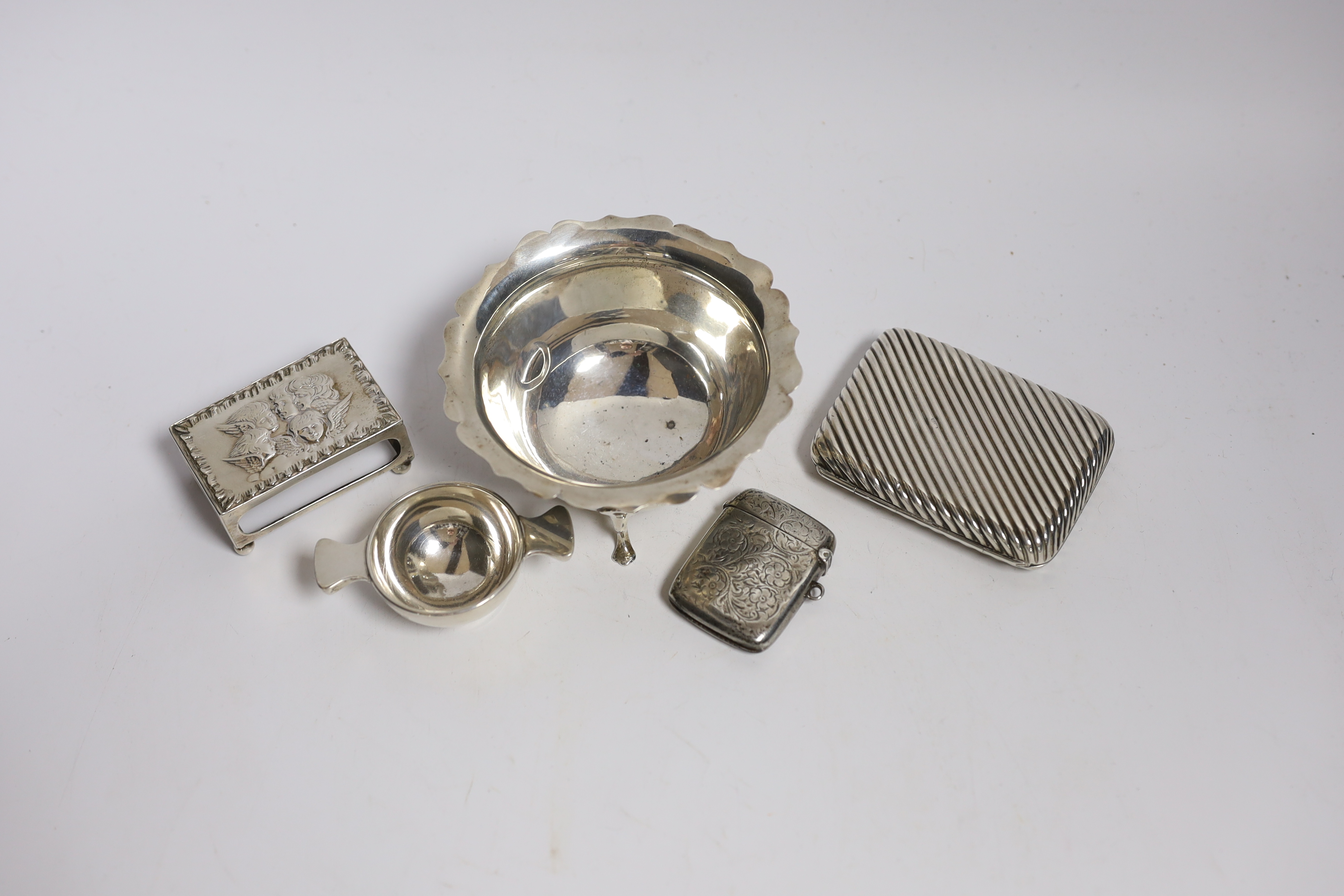 A silver cigarette case, small silver quaich, silver bowl and silver matchbox sleeve.